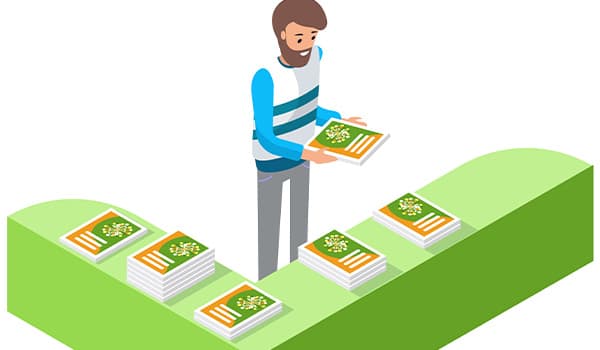 Man standing at table handing out catalogs