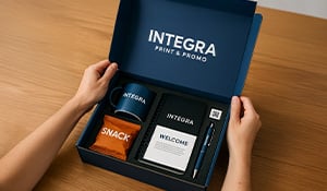 Branded mailing kit with custom box and promotional items on desk