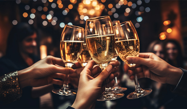 Close-up of hands holding drinks, clinking glasses.